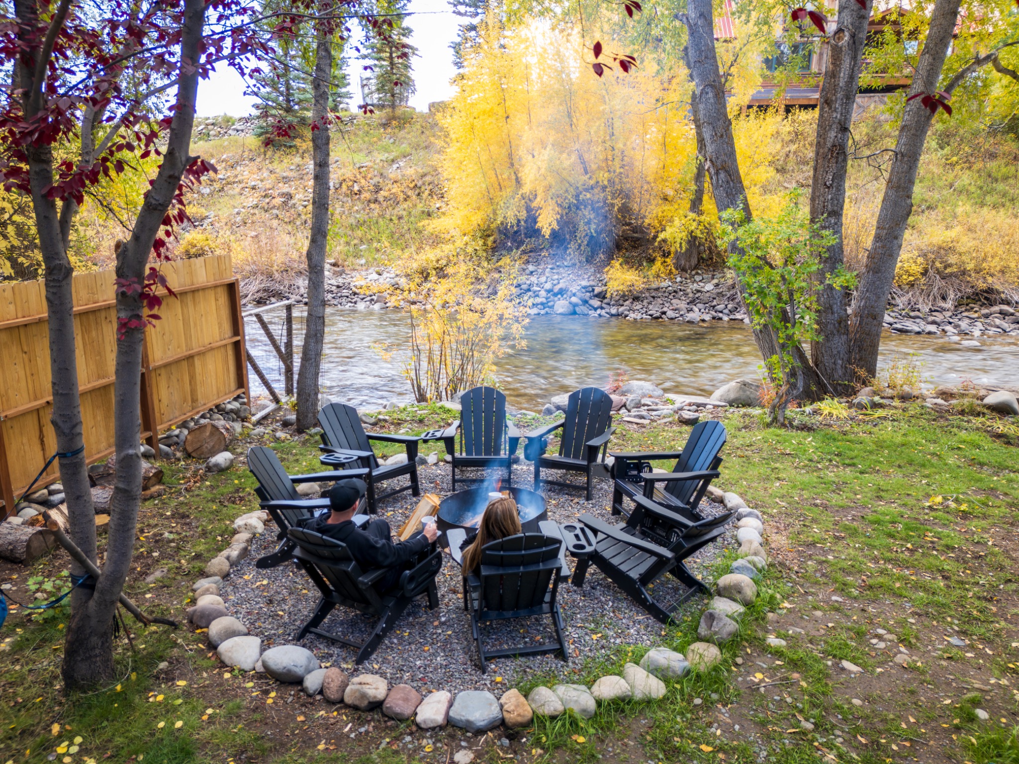 Riverfront cabin surrounded by autumn trees